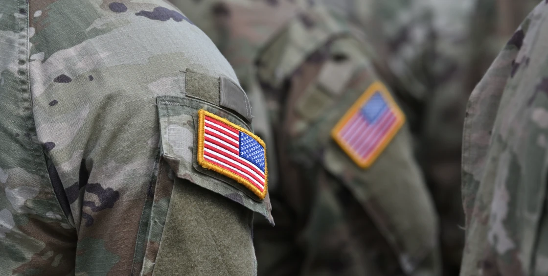Military uniforms displaying American flags